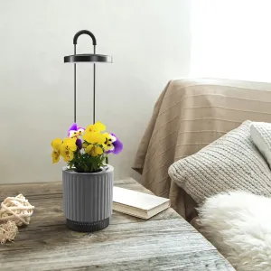 Click & Grow HydroVase, selbstbewässernde Vase mit LED-Beleuchtung, graues Pflanzgefäß mit blühender Zimmerpflanze.